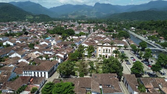 Circling drone view of Paraty, with the mountains and the Atlantic forest that surrounds this Idyllic city