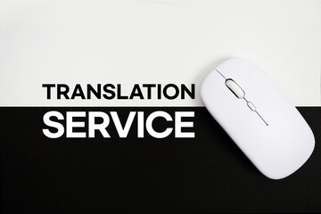 Translation Services text and wireless mouse on white and black background