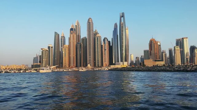 Amazing sunset panorama of Dubai Marina business financial district with skyscraper buildings, no logo