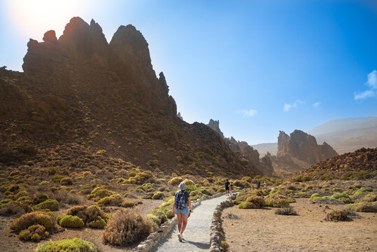 A girl with a backpack walks in the mountains, Teide National Park