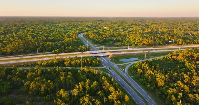 Elevated view of freeway junction near North Port, Florida with trucks and cars rapidly moving along I-75 highway