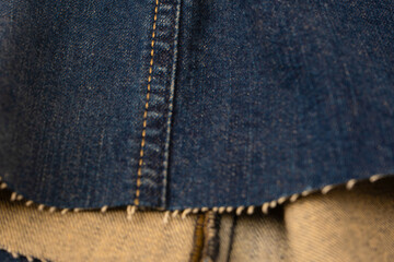 Fototapeta premium Blue denim fabric as a background. Top view.