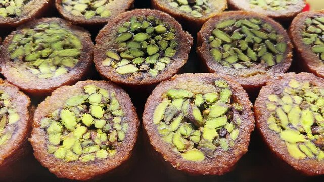 Close-up of pistachio filled traditional arabic sweets displayed in a shop window in Dubai Mall