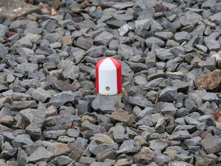 white red metallic cover between the train tracks