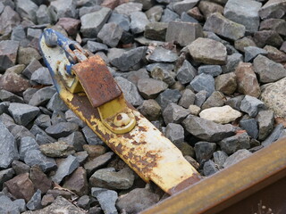 old wheel chock or wheel stop used in the railway industry to secure vehicles against rolling away.