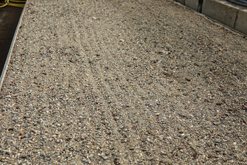 background of gravel in rows for planting succulent plants
