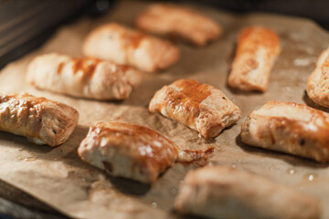 Golden brown pastries baked to perfection on parchment paper.