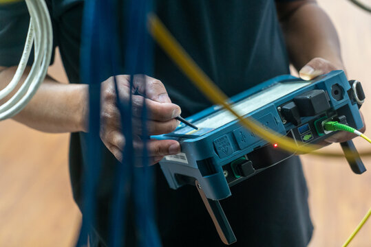 Technician Using Device for Electrical Testing