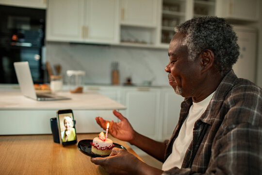 Senior man celebrating birthday on video call at home