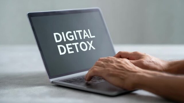 Professional businessman typing on laptop keyboard, demonstrating conscious disconnection from technological stimulation while prioritizing mental wellness in digital saturated workplace