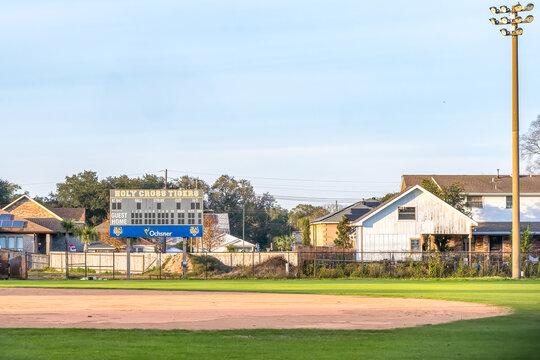 New Orleans, LA, USA - January 1, 2026: Holy Cross High School Baseball Park with Scoreboard, Light Pole and Surrounding Houses in the Gentilly Neighborhood of New Orleans