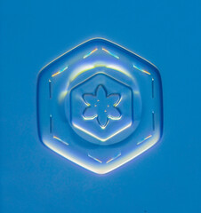 Natural snowflake crystal in blue background