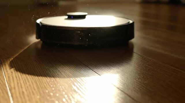 Dust particles floating in sunbeam on wood floor. Cleaning and home concept.