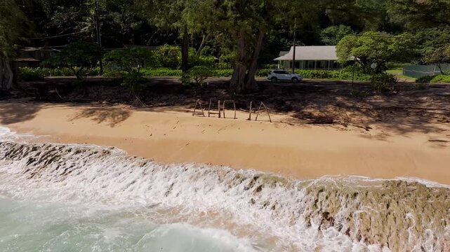 Summer beach view with waves crashing and aloha sign drone video Hawaii Kauai 4K