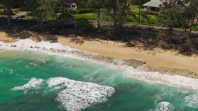 Beautiful tropical beach view with waves crashing on sand drone video Hawaii Kauai 4K