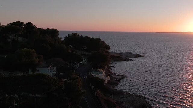 Flying over road and car driving in the sunset, drone video, Antibes, France 4K