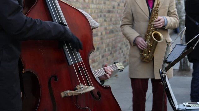 Buskers band on the street, music band with cello saxophone and banjo