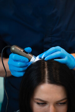 Trichology scalp examination with digital trichoscope for hair analysis.