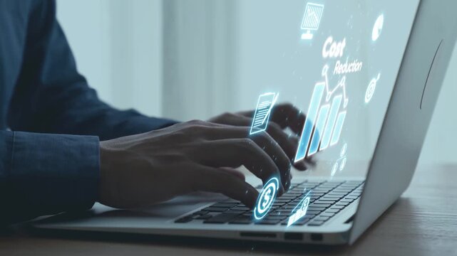 Hands typing on a laptop with digital projections representing data analysis, cost reduction, and statistical growth concepts in a modern workspace environment. Qubit.