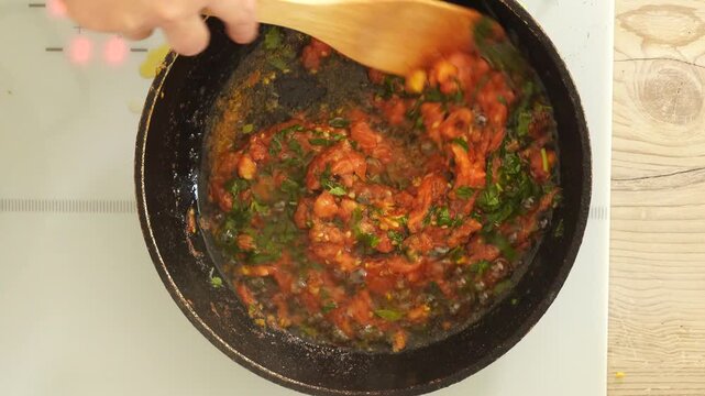 Process of cooking tomato sauce on the pan
