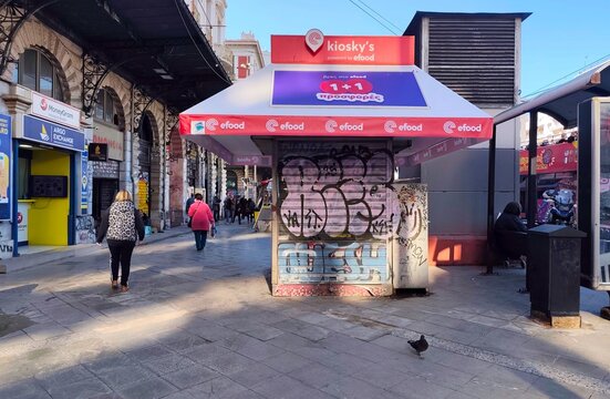 Photo of a closed kiosk (periptero) in Omonoia Square, a small iconic fixture of everyday Greek urban life, standing out on busy sidewalks and squares.