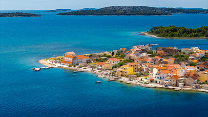 Coastal village on Krapanj island Croatia captured from above with calm sea and historic...