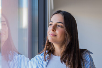Head shot close up dreamy young smiling beautiful woman looking away, visualizing future indoors of...