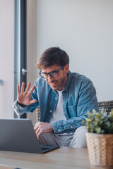 Concentrated skilled millennial caucasian businessman in glasses with mic, taking part in online...