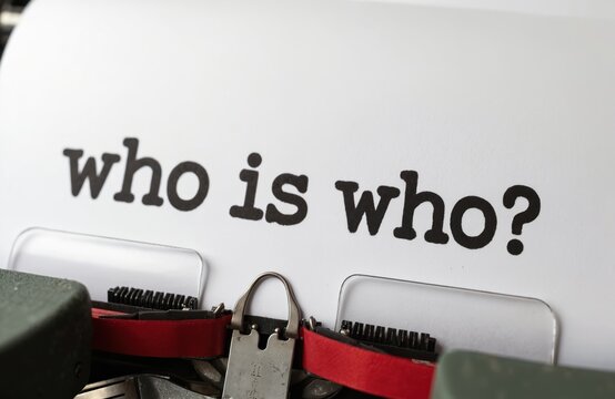 Old typewriter types question who is who on paper. Vintage text focus on identity mystery and enigma. Concept of self discovery research and unknown.