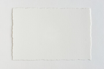 cotton paper with torn edges on a white table © rozaivn58