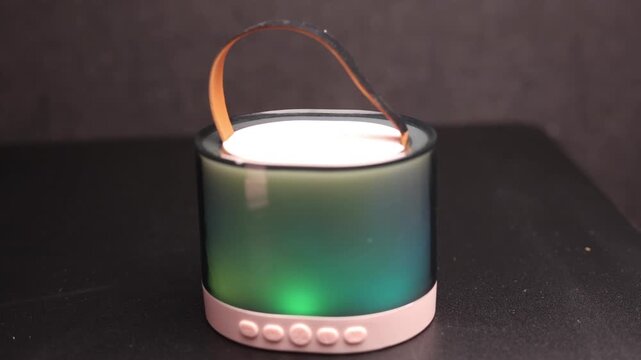 Portable Bluetooth speaker with colorful LED light effects and carrying strap