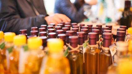 Olive oil bottles on display at an Italian market for tasting and sale