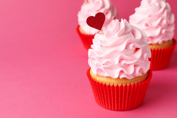 Happy Valentine's Day. Tasty cupcakes with whipped cream on pink background, closeup. Space for text