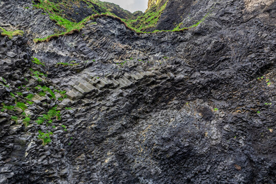 Halsanefshellir Cave curved basalt columns on Reynisfjara Black Sand Beach, Iceland