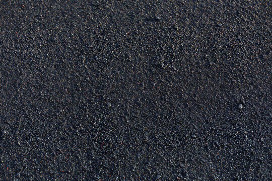 Top down texture of wet black volcanic sand and granules on Reynisfjara Beach, Iceland