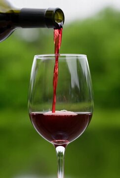 red wine pouring into glass