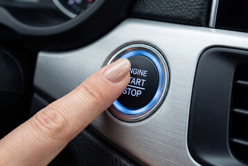 Woman&rsquo;s Finger Pressing the Engine Start Stop Button in a Car