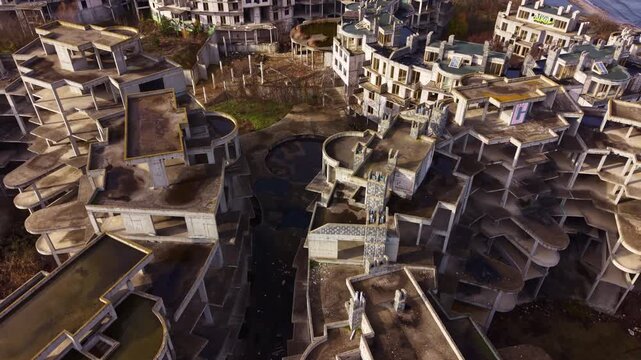 Crumbled structures rise against the evening sky, revealing the eerie remnants of a long-forgotten seaside resort. Nature encroaches upon the empty spaces, whispering stories of the past.