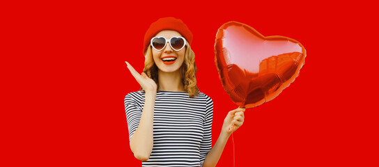 Naklejka na ściany i meble Portrait of happy cheerful smiling woman with red heart shaped balloon