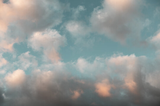 Soft pastel clouds in a bright blue sky