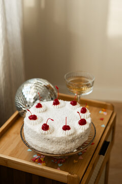 Sponge cake with cream cheese frosting and cherries