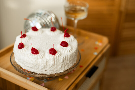 Sponge cake with cherries and coconut flakes decoration