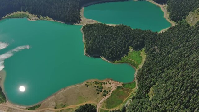 Aerial around view of Black Lake in mountain Durmitor park at summer, Montenegro, 4k