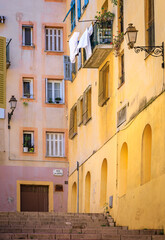 Fototapeta premium Colorful traditional houses line a narrow street in the Old Town Nice, France