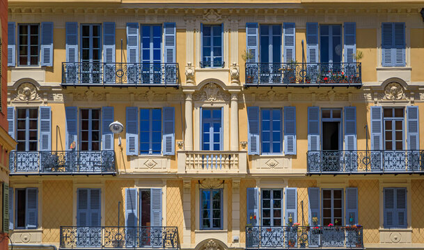 Traditional houses with ornate metal work and shutters in the streets of Old Town Vielle Ville in Nice, South of France
