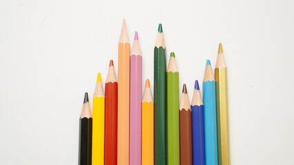 Fototapeta premium A row of pencils with different colors and one of them is green
