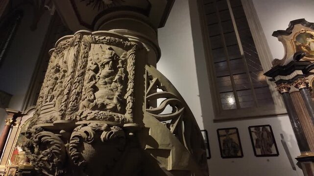 Slow motion macro of the ornate stone pulpit in St. James Church, Brno