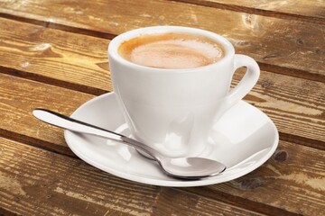 Obraz premium Ceramic white cup with coffee inside.