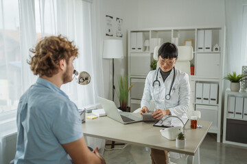 Obraz premium Doctor preparing blood pressure cuff for male patient