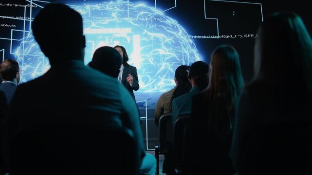 Listeners applauding asian IT expert presenting AI neural networks concept and data science visuals. Businessman speaker presents investment strategy to investors in conference hall. Camera A.